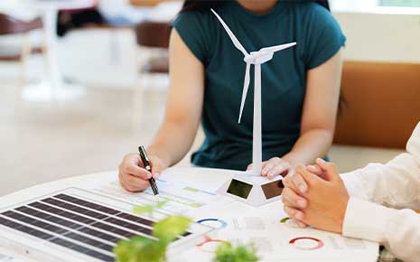 Two college students research and study for green energy business